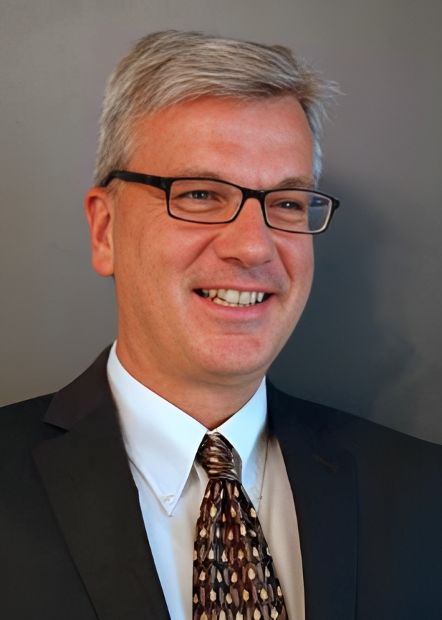 A headshot of Brad Friesen, smiling.