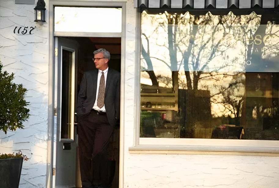 Brad leaning against the door to his office on Newport Avenue.